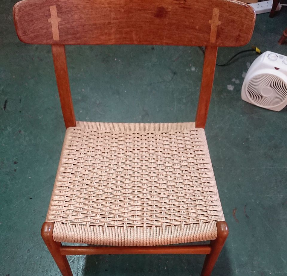 Dining chair with a woven Danish cord seat and contrasting keys in the back rail