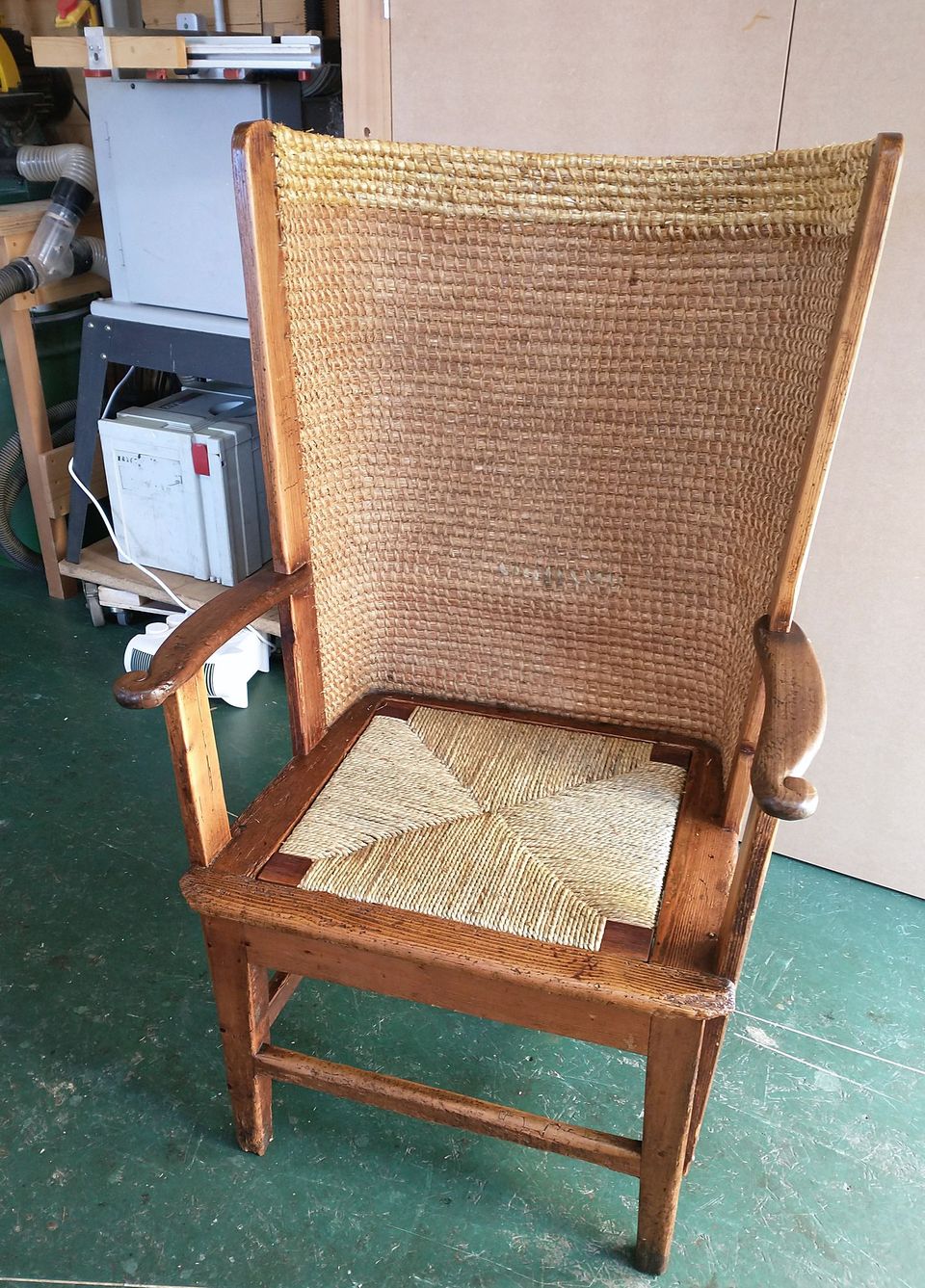 The same Orkney-style chair after restoration, with its straw back and a new rush seat