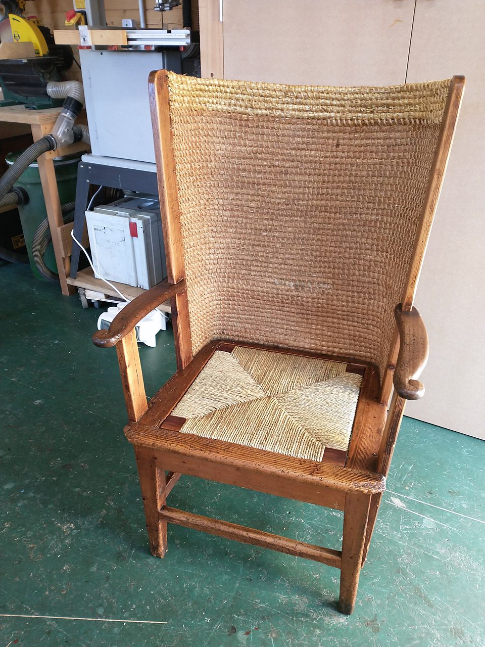 The same Orkney-style chair after restoration, with its straw back and a new rush seat